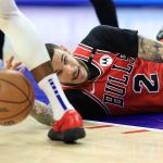 New Cavaliers Guard Lonzo Ball dives for a loose ball during a game.