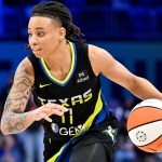 JJ Quinerly of the Dallas Wings drives inside the paint in a game.