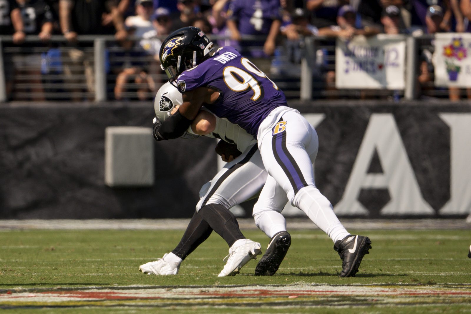 Sep 15, 2024; Baltimore, Maryland, USA; Baltimore Ravens linebacker Odafe Oweh (99) sacks Las Vegas Raiders quarterback Gardner Minshew (15) during the first quarter at M&T Bank Stadium. Mandatory Credit: Tommy Gilligan-Imagn Images