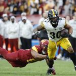 Nov 10, 2024; Landover, Maryland, USA; Pittsburgh Steelers running back Jaylen Warren (30) carries the ball past Washington Commanders linebacker Bobby Wagner (54) during the second half at Northwest Stadium.
