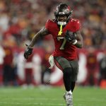 Jan 12, 2025; Tampa, Florida, USA; Tampa Bay Buccaneers running back Bucky Irving (7) runs during the fourth quarter of a NFC wild card playoff against the Washington Commanders at Raymond James Stadium.