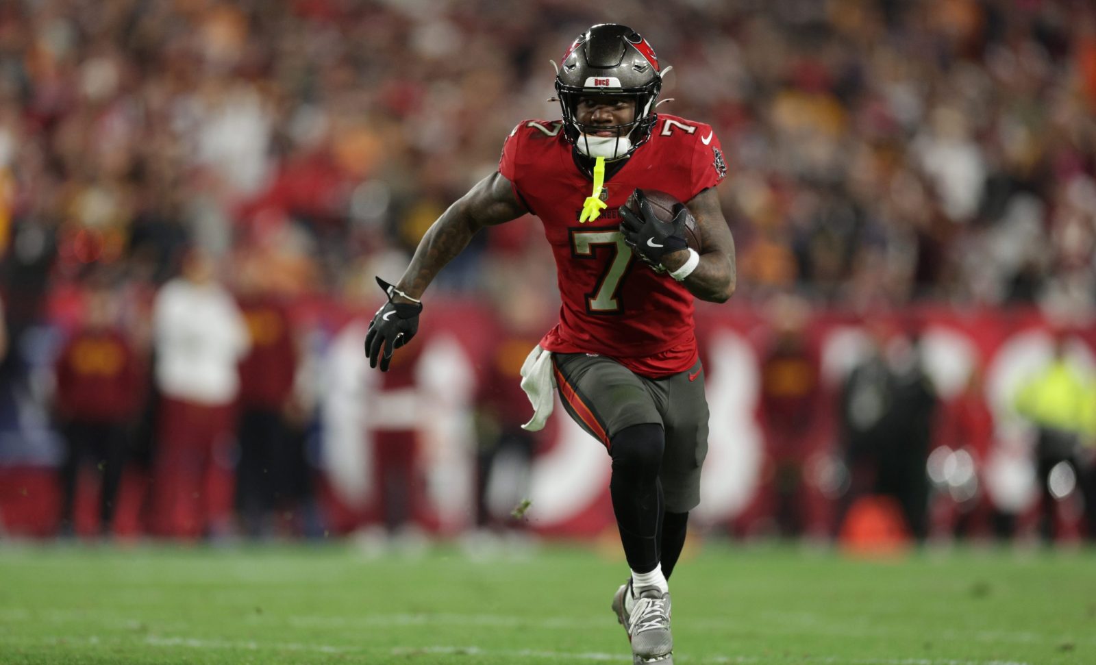 Jan 12, 2025; Tampa, Florida, USA; Tampa Bay Buccaneers running back Bucky Irving (7) runs during the fourth quarter of a NFC wild card playoff against the Washington Commanders at Raymond James Stadium.