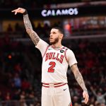 Feb 28, 2025; Chicago, Illinois, USA; Chicago Bulls forward Lonzo Ball (2) hits a three point shot against Toronto Raptors guard Jamal Shead (23) during overtime at the United Center.
