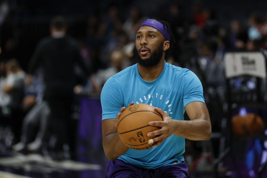Apr 6, 2025; Charlotte, North Carolina, USA; Charlotte Hornets forward Josh Okogie (12) shoots before a game against the Chicago Bulls at Spectrum Center.