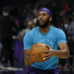 Apr 6, 2025; Charlotte, North Carolina, USA; Charlotte Hornets forward Josh Okogie (12) shoots before a game against the Chicago Bulls at Spectrum Center.