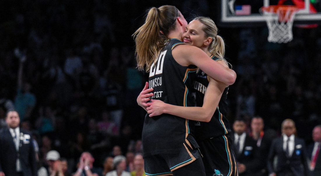 Jul 16, 2025; Brooklyn, New York, USA; New York Liberty guard Marine Johannes (23) is embraced by guard Sabrina Ionescu (20) after hitting a three point basket against the Indiana Fever during the second half at Barclays Center. Mandatory Credit: John Jones-Imagn Images