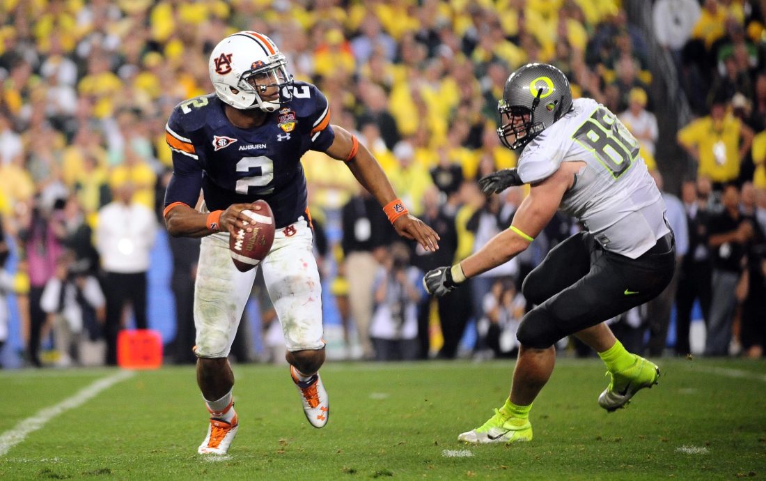 Jan 10, 2011; Glendale, AZ, USA; Auburn Tigers quarterback Cameron Newton (2) is pressured by Oregon Ducks defensive tackle Brandon Bair (88) during the fourth quarter of the 2011 BCS National Championship game at University of Phoenix Stadium. Mandatory Credit: Mark J. Rebilas-USA TODAY Sports
