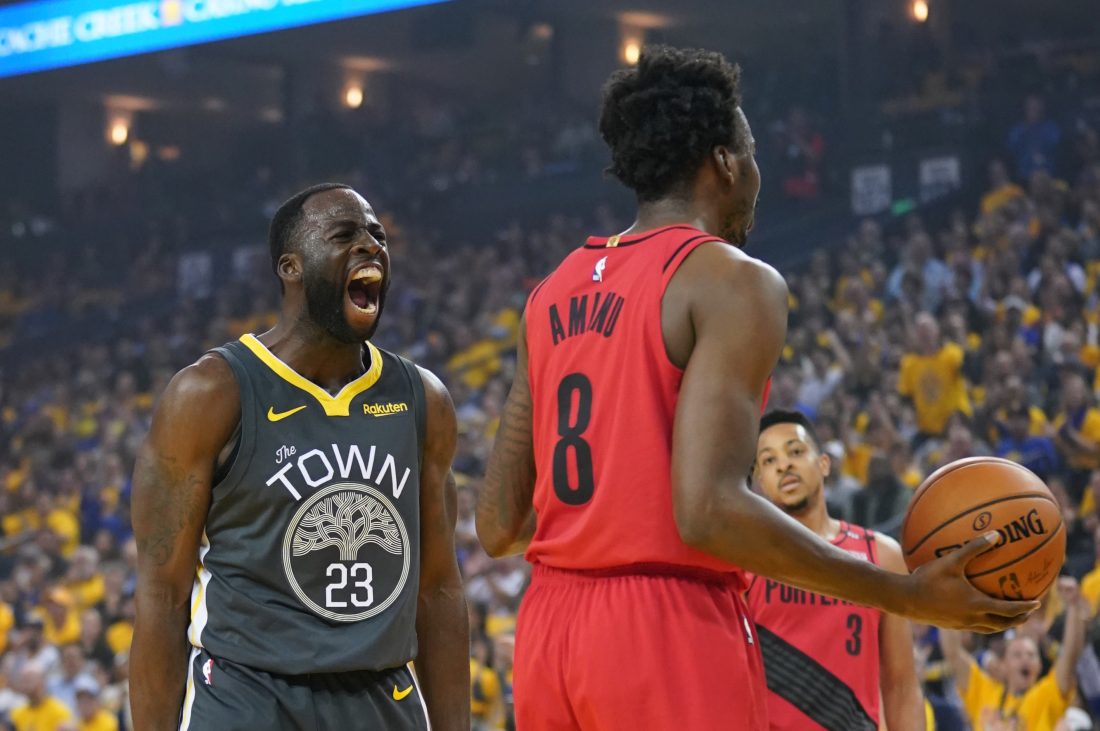 May 16, 2019; Oakland, CA, USA; Golden State Warriors forward Draymond Green (23) celebrates against Portland Trail Blazers forward Al-Farouq Aminu (8) during the first quarter in game two of the Western conference finals of the 2019 NBA Playoffs at Oracle Arena. Mandatory Credit: Kyle Terada-USA TODAY Sports