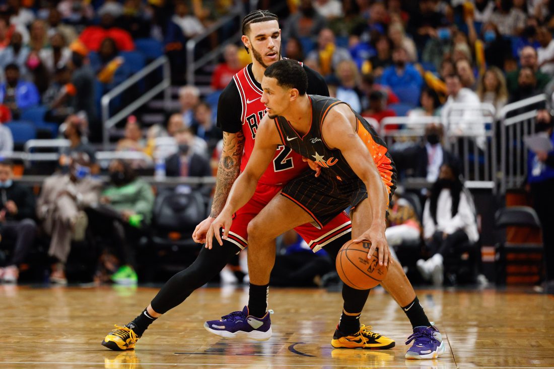Nov 26, 2021; Orlando, Florida, USA; Chicago Bulls guard Lonzo Ball (2) defends Orlando Magic guard Jalen Suggs (4) in the second half at Amway Center. Mandatory Credit: Nathan Ray Seebeck-USA TODAY Sports