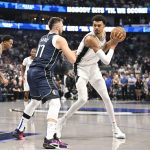 Oct 24, 2024; Dallas, Texas, USA; San Antonio Spurs center Victor Wembanyama (1) looks to move the ball past Dallas Mavericks guard Luka Doncic (77) during the first quarter at the American Airlines Center.
