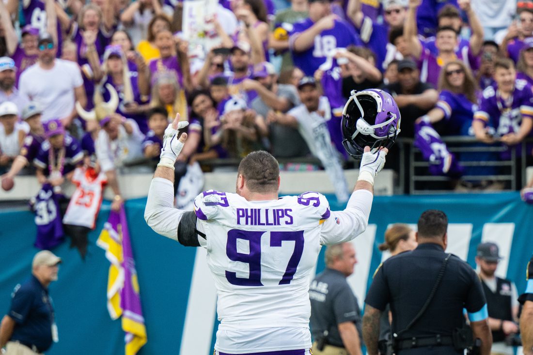 Nov 10, 2024; Jacksonville, Florida, USA; Minnesota Vikings defensive lineman Harrison Phillips (97) celebrates with the fans after the win against the Jacksonville Jaguars at EverBank Stadium. Mandatory Credit: Jeremy Reper-Imagn Images
