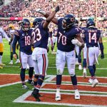 Nov 17, 2024; Chicago, Illinois, USA; Chicago Bears running back Roschon Johnson (23) celebrates his rushing touchdown with offensive tackle Braxton Jones (70) against the Green Bay Packers during the second quarter at Soldier Field.