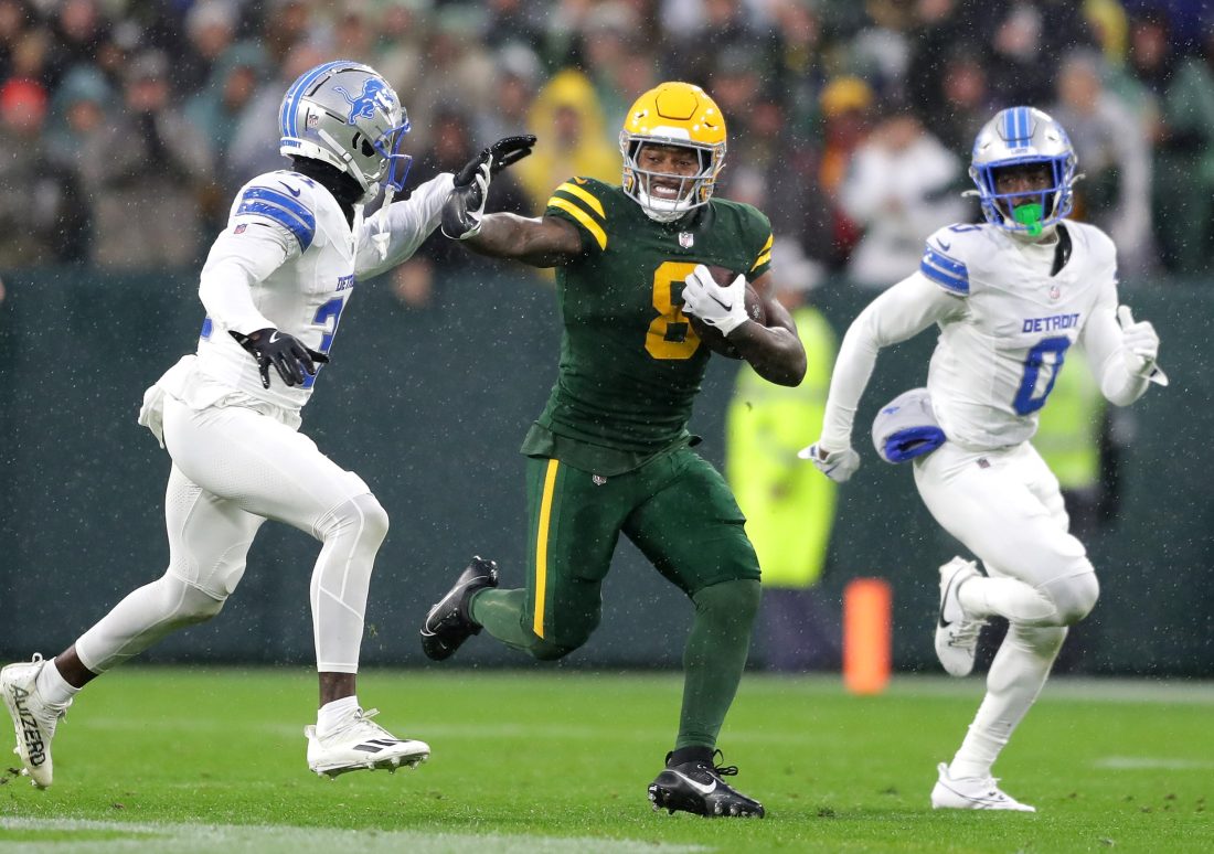 Green Bay Packers running back Josh Jacobs (8) against Detroit Lions safety Kerby Joseph (31) and cornerback Terrion Arnold (0) on Sunday, Nov. 3, 2024, at Lambeau Field in Green Bay. The Lions defeated the Packers 24-14.
