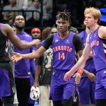 Dec 19, 2024; Toronto, Ontario, CAN; Toronto Raptors guard Ja'Kobe Walter (14) is greeted by forward Jonathan Mogbo (2) and forward Gradey Dick (1) after making a three point basket against the Brooklyn Nets in the first half at Scotiabank Arena. Mandatory Credit: Dan Hamilton-Imagn Images