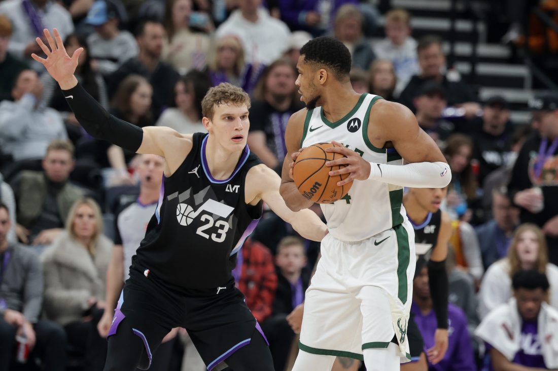 Jan 27, 2025; Salt Lake City, Utah, USA; Milwaukee Bucks forward Giannis Antetokounmpo (34) keeps the ball away from Utah Jazz forward Lauri Markkanen (23) during the second half at Delta Center. Mandatory Credit: Chris Nicoll-Imagn Images