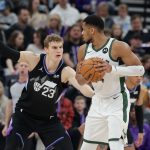 Jan 27, 2025; Salt Lake City, Utah, USA; Milwaukee Bucks forward Giannis Antetokounmpo (34) keeps the ball away from Utah Jazz forward Lauri Markkanen (23) during the second half at Delta Center. Mandatory Credit: Chris Nicoll-Imagn Images