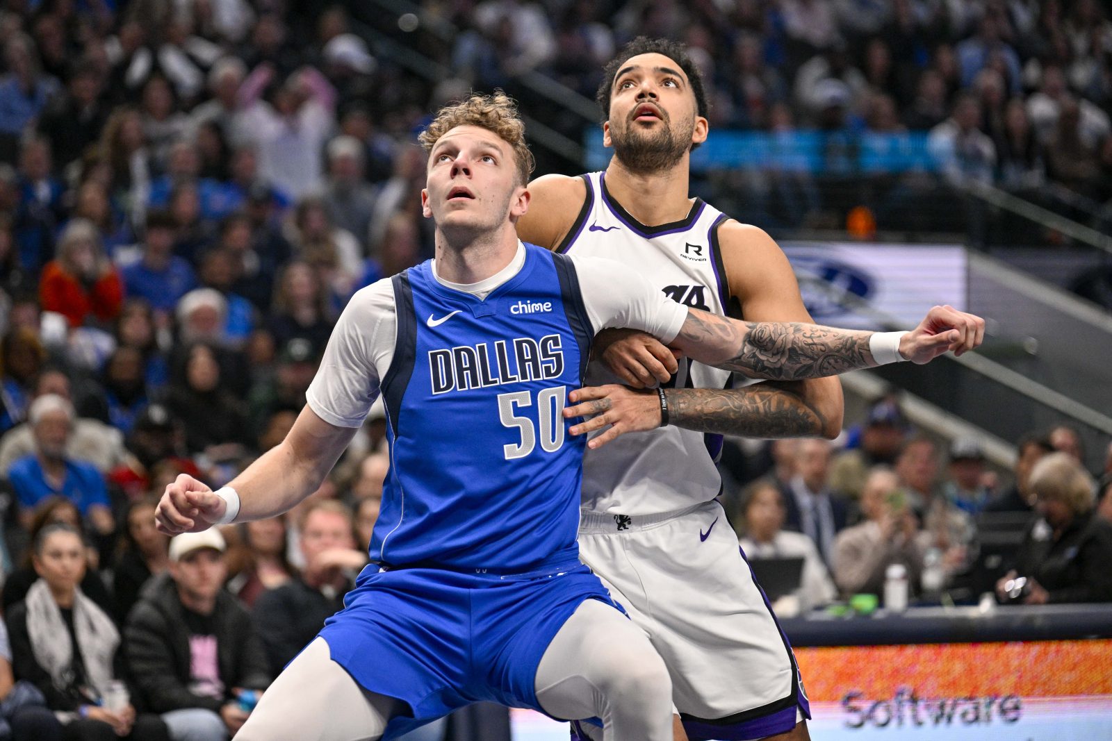 Feb 10, 2025; Dallas, Texas, USA; Dallas Mavericks center Kylor Kelley (50) and Sacramento Kings forward Trey Lyles (41) look for the ball during the second half at the American Airlines Center. Mandatory Credit: Jerome Miron-Imagn Images