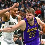 Mar 13, 2025; Milwaukee, Wisconsin, USA; Los Angeles Lakers guard Luka Doncic (77) drives to the basket against Milwaukee Bucks forward Giannis Antetokounmpo (34) in the third quarter at Fiserv Forum.