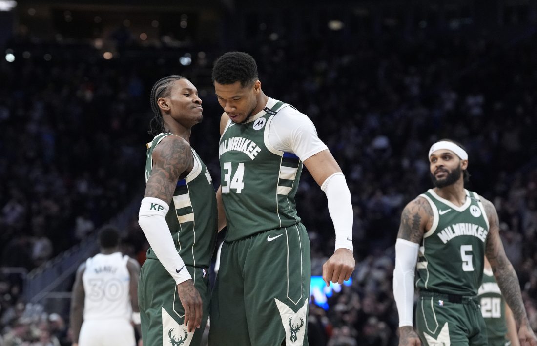 Apr 8, 2025; Milwaukee, Wisconsin, USA; Milwaukee Bucks guard Kevin Porter Jr. (3) and Milwaukee Bucks forward Giannis Antetokounmpo (34) celebrate as the clock winds down in their 110-103 comeback victory over the Minnesota Timberwolves at Fiserv Forum. Mandatory Credit: Michael McLoone-Imagn Images