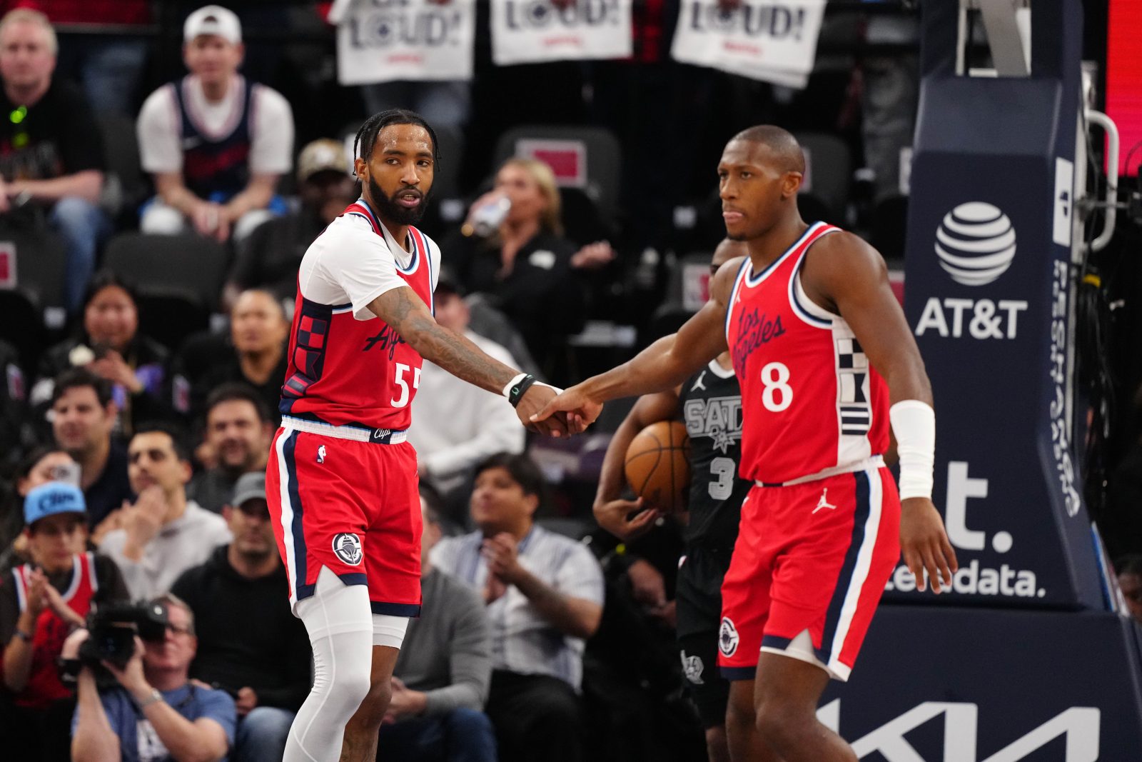Apr 8, 2025; Inglewood, California, USA; LA Clippers forward Derrick Jones Jr. (55) and guard Kris Dunn (8) celebrate against the San Antonio Spurs in the first half at Intuit Dome. Mandatory Credit: Kirby Lee-Imagn Images