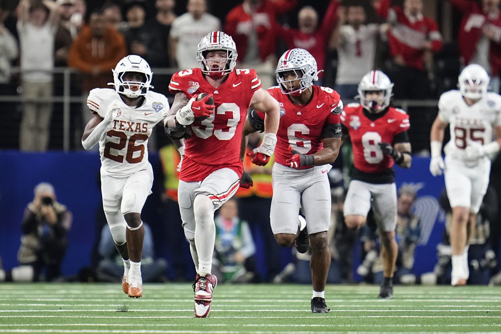 Ohio State Buckeyes defensive end Jack Sawyer (33) returns a fumble recovery for a touchdown after sacking Texas Longhorns quarterback Quinn Ewers (3) during the second half of the Cotton Bowl Classic College Football Playoff semifinal game at AT&T Stadium in Arlington, Texas on Jan. 10, 2025. Sawyer returned the fumble for a touchdown, and Ohio State won 28-14.
