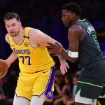 Apr 30, 2025; Los Angeles, California, USA; Los Angeles Lakers guard Luka Doncic (77) controls the ball against Minnesota Timberwolves guard Anthony Edwards (5) during the first half in game five of first round for the 2025 NBA Playoffs at Crypto.com Arena. Mandatory Credit: Gary A. Vasquez-Imagn Images