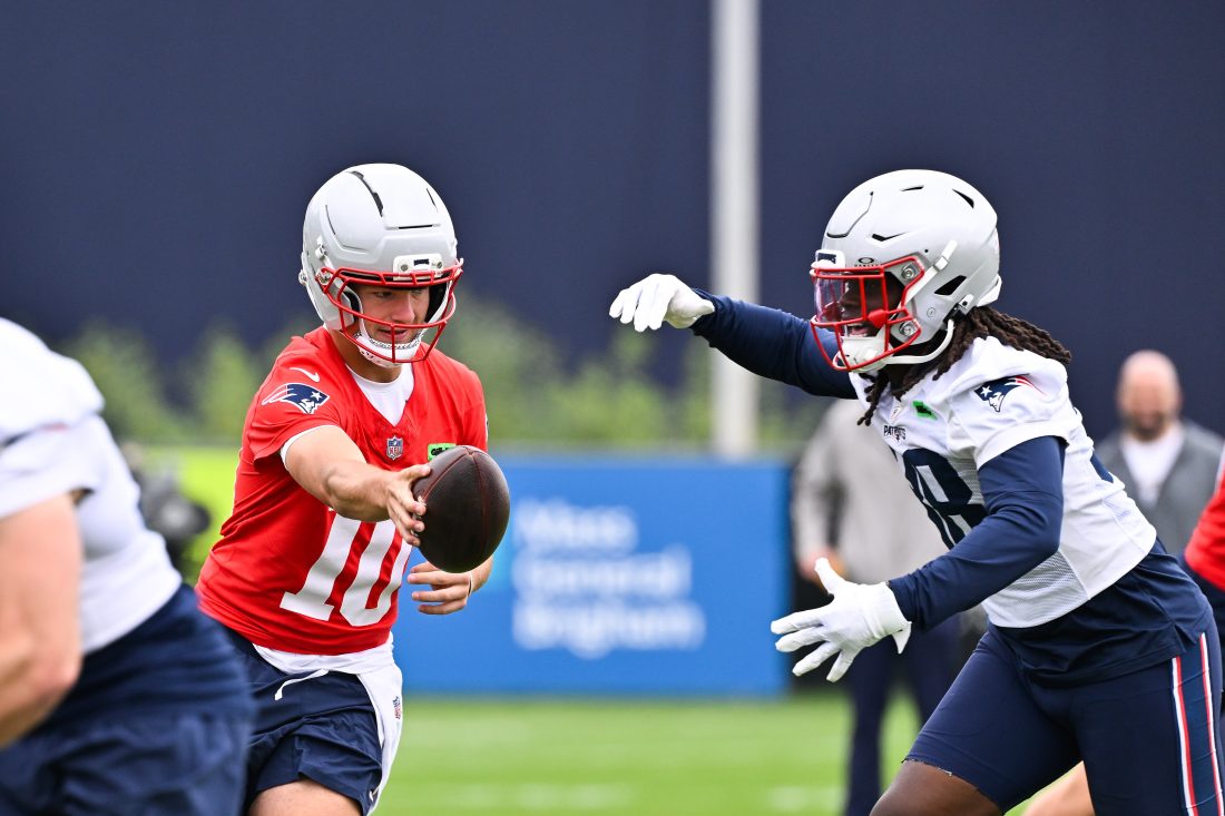 Jun 9, 2025; Foxborough, MA, USA; New England Patriots quarterback Drake Maye (10) hands the ball to running back Rhamondre Stevenson (38) during minicamp at Gillette Stadium. Mandatory Credit: Eric Canha-Imagn Images