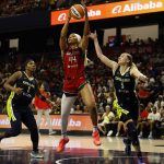 Jun 22, 2025; Washington, District of Columbia, USA; Washington Mystics forward Kiki Iriafen (44) catches a long pass as Dallas Wings guard Paige Bueckers (5) and Wings forward Myisha Hines-Allen (2) defend in the second half at Entertainment & Sports Arena. Mandatory Credit: Geoff Burke-Imagn Images