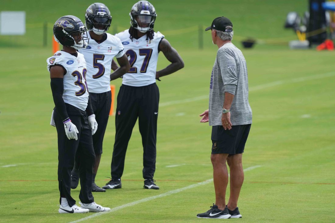 Jul 24, 2025; Owings Mills, MD, USA; Baltimore Ravens coach Chuck Pagano (right) talks with the defense during training camp at the Under Armour Performance Center. Mandatory Credit: Mitch Stringer-Imagn Images