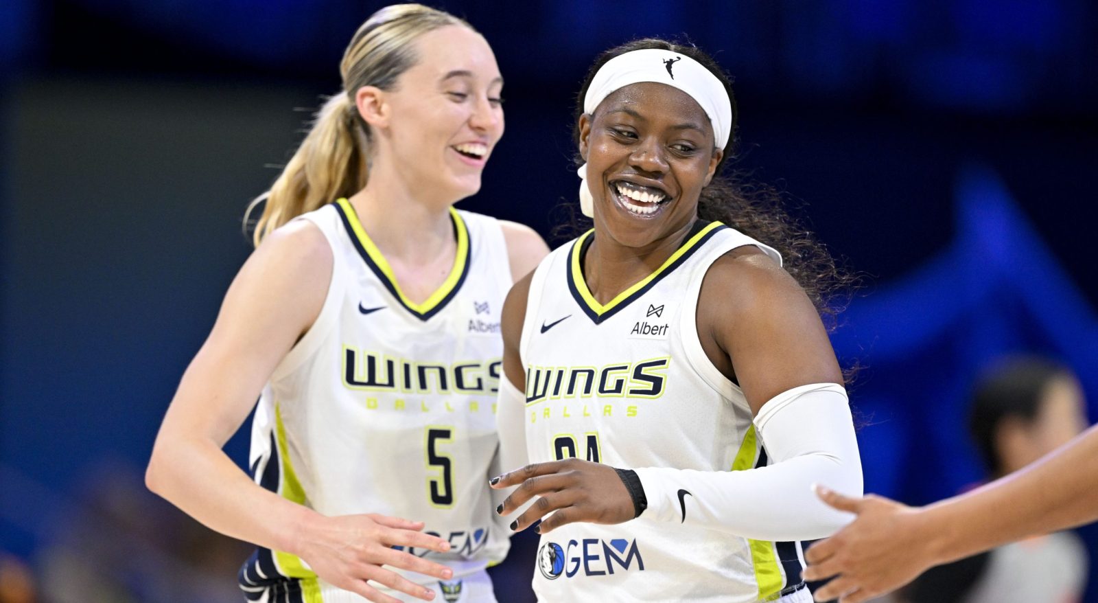 Jul 28, 2025; Arlington, Texas, USA; Dallas Wings guard Paige Bueckers (5) and guard Arike Ogunbowale (24) celebrate during the second half against the New York Liberty at College Park Center. Mandatory Credit: Jerome Miron-Imagn Images