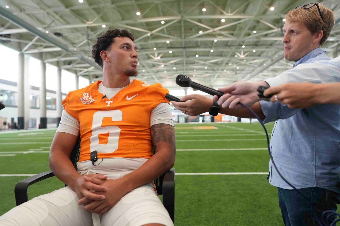 Knox News reporter Adam Sparks speaks to Tennessee quarterback Joey Aguilar (6) during football media day, in Knoxville, Tennessee, July 29, 2025.
