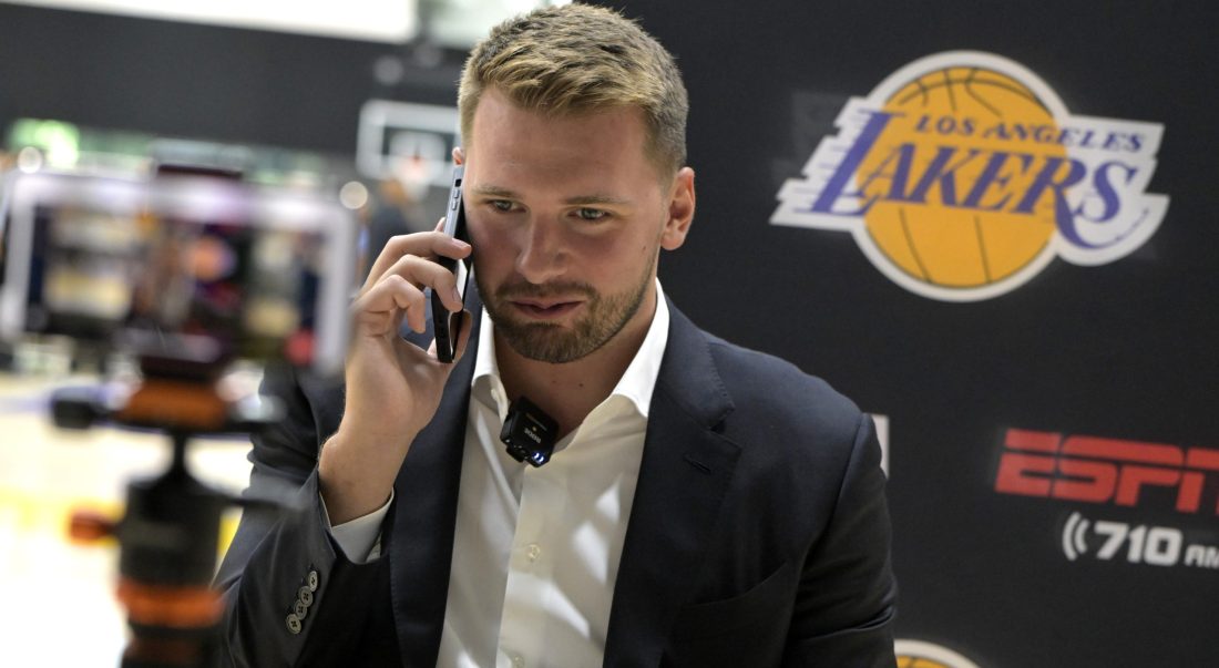 Aug 2, 2025; El Segundo, CA, USA; Los Angeles Lakers Luka Doncic (77) is interviewed by ESPN LA radio following a press conference announcing the signing of a 3-year, $165 million contract extension at UCLA Health Training Center. Mandatory Credit: Jayne Kamin-Oncea-Imagn Images