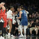 Aug 2, 2025; Las Vegas, Nevada, USA; Players from the Las Vegas Aces and Minnesota Lynx surround Lynx forward Napheesa Collier (24) after she does down with an injury in the third quarter of their game at Michelob Ultra Arena.