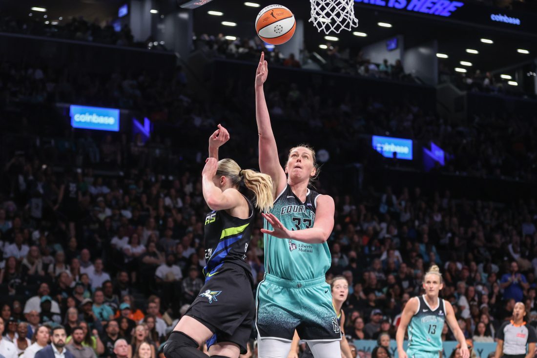 Aug 5, 2025; Brooklyn, New York, USA; New York Liberty forward Emma Meesseman (33) looks to drive past Dallas Wings guard Paige Bueckers (5) in the third quarter at Barclays Center. Mandatory Credit: Wendell Cruz-Imagn Images