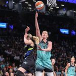 Aug 5, 2025; Brooklyn, New York, USA; New York Liberty forward Emma Meesseman (33) looks to drive past Dallas Wings guard Paige Bueckers (5) in the third quarter at Barclays Center. Mandatory Credit: Wendell Cruz-Imagn Images