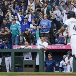 Aug 6, 2025; Seattle, Washington, USA; Fans and Seattle Mariners players in the dugout cheer following a three-run home run by center fielder Julio Rodríguez (44) against the Chicago White Sox during the second inning at T-Mobile Park. Mandatory Credit: Joe Nicholson-Imagn Images