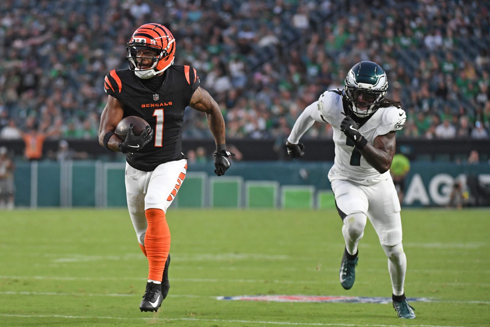 Aug 7, 2025; Philadelphia, Pennsylvania, USA; Cincinnati Bengals wide receiver Ja'Marr Chase (1) runs past Philadelphia Eagles cornerback Kelee Ringo (7) on a 36-yard touchdown catch during the first quarter against the Philadelphia Eagles at Lincoln Financial Field.