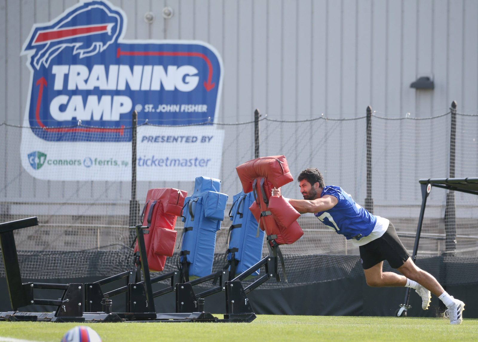 Bills edge A.J. Epenesa hits the blocking sled as he puts in reps alone on the practice field during the second day of Buffalo Bills training camp at St. John Fisher University Thursday, July 24, 2025 in Pittsford.