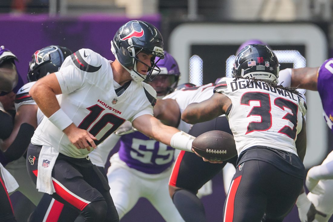 Aug 9, 2025; Minneapolis, Minnesota, USA; Houston Texans quarterback Davis Mills (10) hands the ball off to running back Dare Ogunbowale (33) against the Minnesota Vikings in the first quarter at U.S. Bank Stadium. Mandatory Credit: Brad Rempel-Imagn Images
