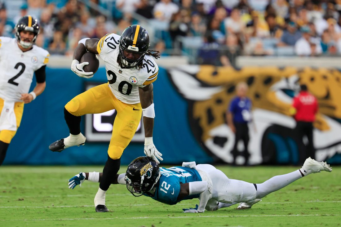 Pittsburgh Steelers running back Kaleb Johnson (20) outpaces Jacksonville Jaguars wide receiver Travis Hunter (12) who can’t make the tackle during the second quarter of an NFL preseason matchup at EverBank Stadium, Saturday, Aug. 9, 2025 in Jacksonville, Fla. [Corey Perrine/Florida Times-Union]