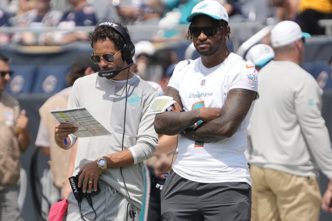 Aug 10, 2025; Chicago, Illinois, USA;Miami Dolphins head coach Mike McDaniels with quarterback Tua Tagovailoa (1) on thee sidelines during the second half of a game against the Chicago Bears at Soldier Field. Mandatory Credit: David Banks-Imagn Images
