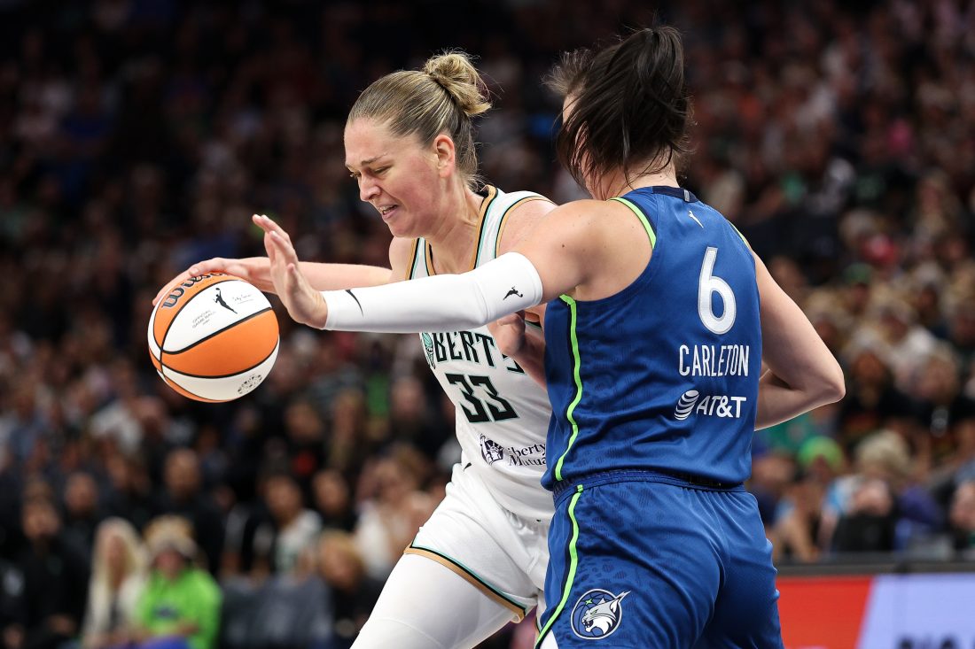 Aug 16, 2025; Minneapolis, Minnesota, USA; New York Liberty center Emma Meesseman (33) drives towards the basket as Minnesota Lynx forward Bridget Carleton (6) defends during the first quarter at Target Center. Mandatory Credit: Matt Krohn-Imagn Images