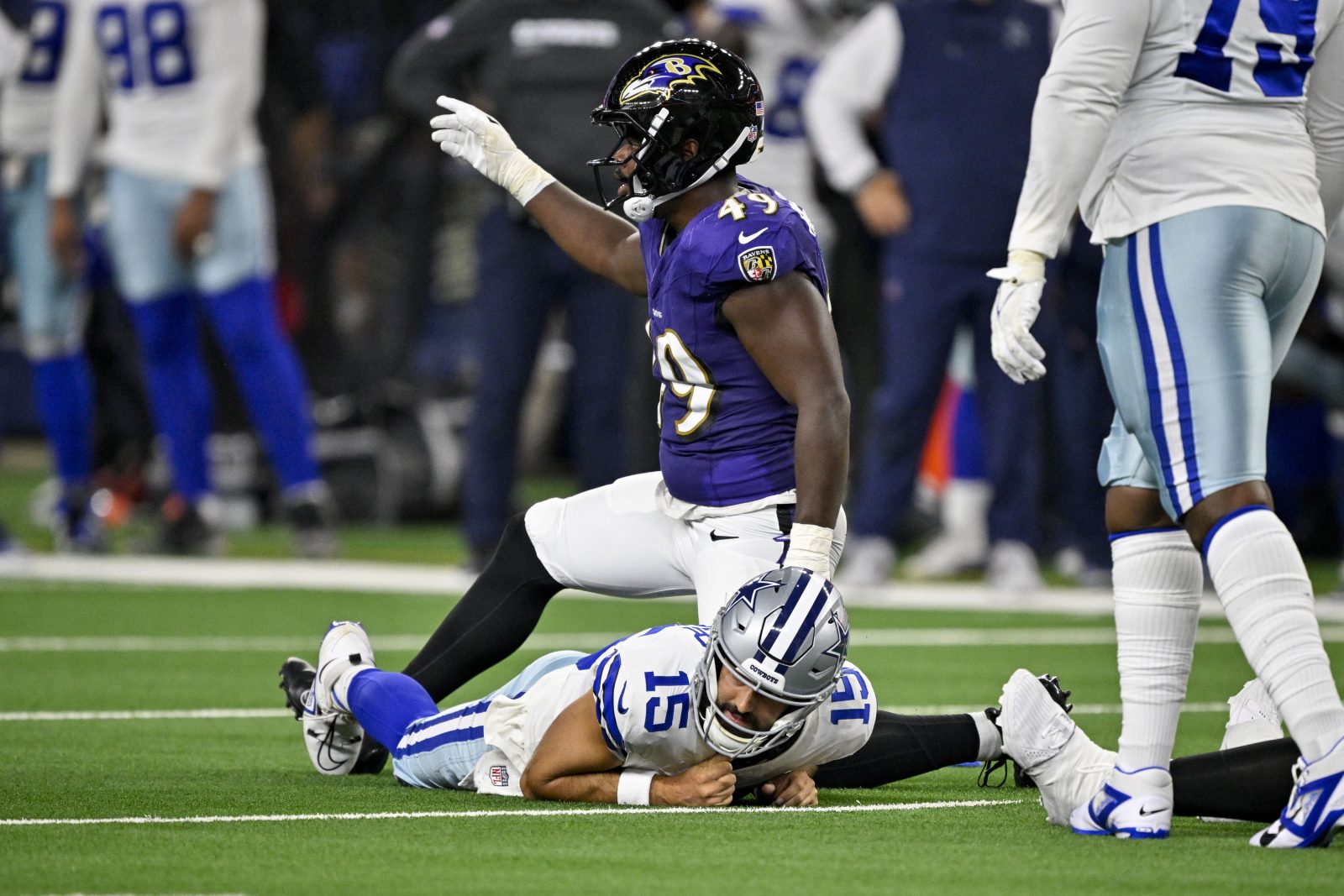 Aug 16, 2025; Arlington, Texas, USA; Baltimore Ravens linebacker Jay Higgins IV (49) sacks Dallas Cowboys quarterback Will Grier (15) during the second half at AT&T Stadium. Mandatory Credit: Jerome Miron-Imagn Images