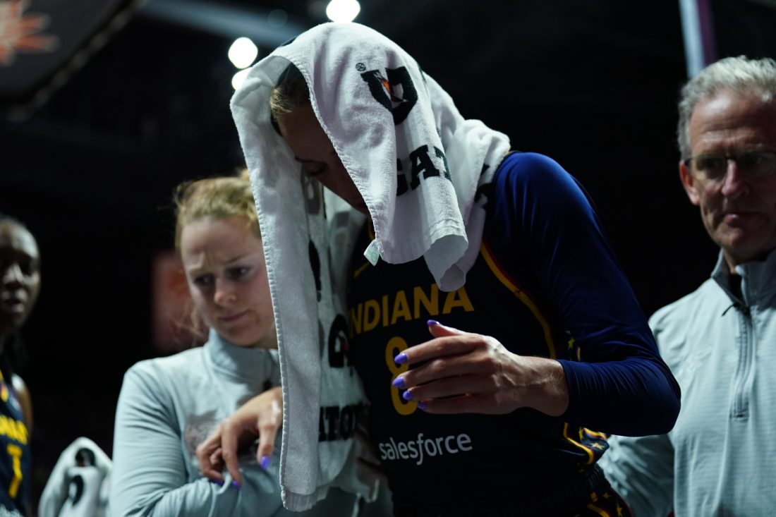 Aug 17, 2025; Uncasville, Connecticut, USA; Indiana Fever guard Sophie Cunningham (8) is helped off the court injured as they take on the Connecticut Sun in the first half at Mohegan Sun Arena. Mandatory Credit: David Butler II-Imagn Images