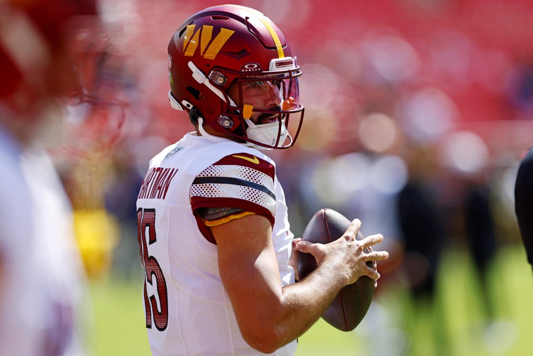 Aug 23, 2025; Landover, Maryland, USA; Washington Commanders quarterback Sam Hartman (15) warms up before playing against the Baltimore Ravens at Northwest Stadium. Mandatory Credit: Peter Casey-Imagn Images