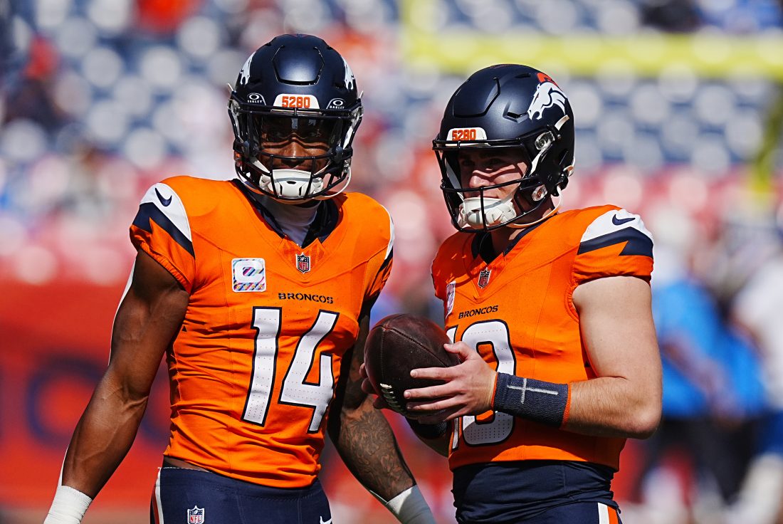 Oct 13, 2024; Denver, Colorado, USA; Denver Broncos wide receiver Courtland Sutton (14) and quarterback Bo Nix (10) warm up before the game against the Los Angeles Chargers at Empower Field at Mile High. Mandatory Credit: Ron Chenoy-Imagn Images