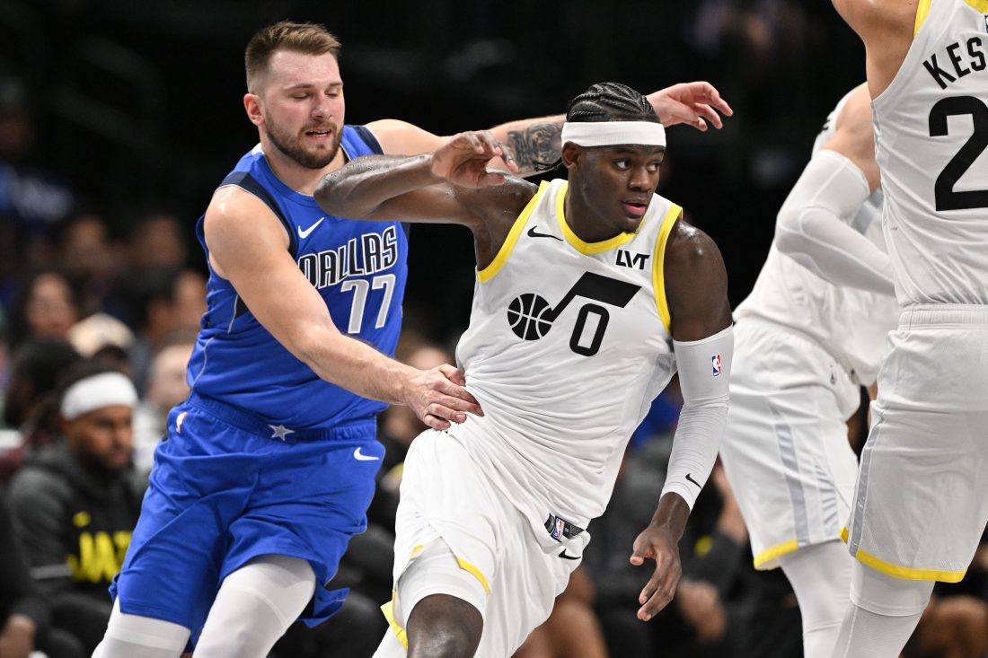 Oct 28, 2024; Dallas, Texas, USA; Utah Jazz forward Taylor Hendricks (0) runs past Dallas Mavericks guard Luka Doncic (77) during the second half at the American Airlines Center.