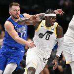 Oct 28, 2024; Dallas, Texas, USA; Utah Jazz forward Taylor Hendricks (0) runs past Dallas Mavericks guard Luka Doncic (77) during the second half at the American Airlines Center.