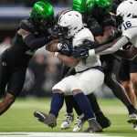 Penn State Nittany Lions running back Kaytron Allen (13) is stopped by Oregon Ducks defensive back Nikko Reed (9) on Saturday, Dec. 7, 2024, during the Big Ten Championship game at Lucas Oil Stadium in Indianapolis.