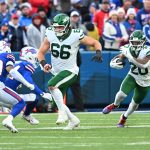 Dec 29, 2024; Orchard Park, New York, USA; New York Jets center Joe Tippmann (66) leads a block for running back Breece Hall (20) as Buffalo Bills cornerback Cam Lewis (39) tries to make a tackle in the fourth quarter at Highmark Stadium. Mandatory Credit: Mark Konezny-Imagn Images